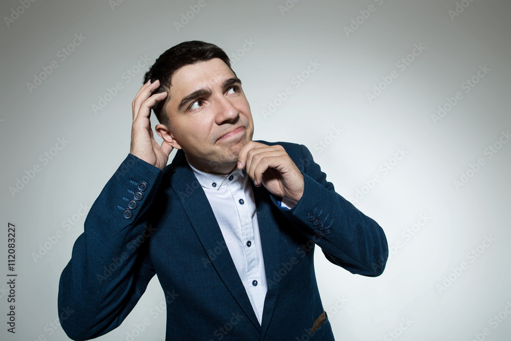 Naklejka premium A young man with a suit thinking