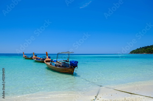 fishing boat against clear sea and blue sky