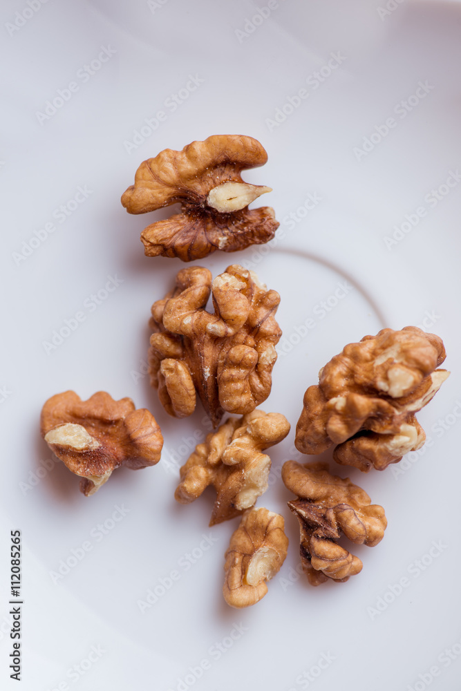 Close-up walnut on a white background. Macro shot. Close-up walnut on a white background. Macro shot.