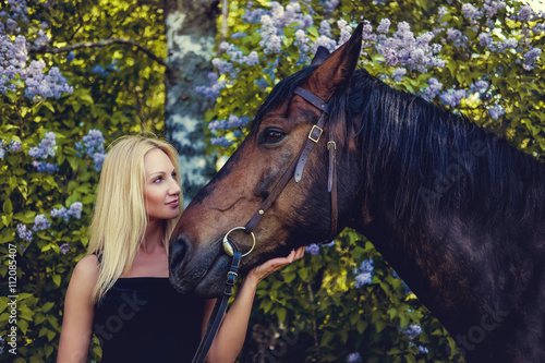 Portrait of blond female with horse.