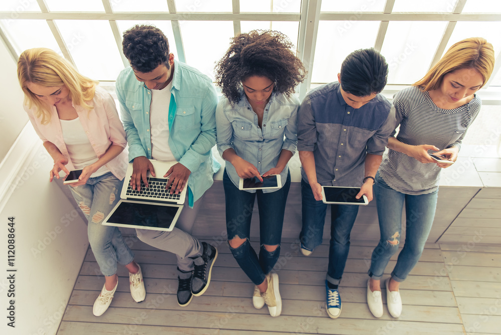 Fototapeta premium Young people with gadgets