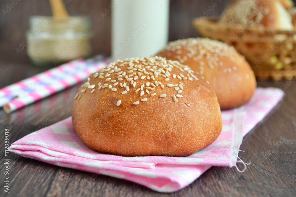 homemade buns with sesame seeds and milk for breakfast