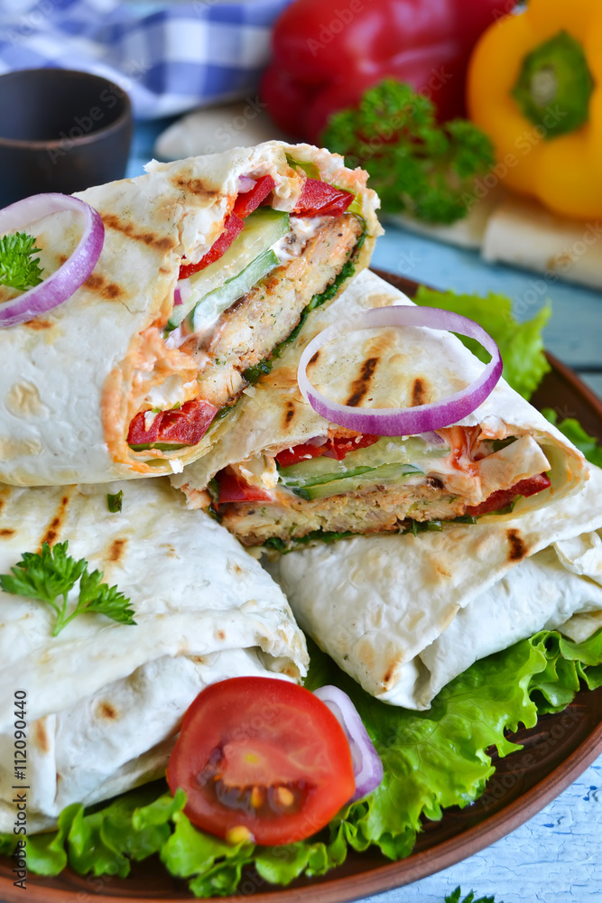 shawarma Lavash with chicken, tomatoes, lettuce and peppers on a shawarma Lavash with chicken, tomatoes, lettuce and peppers on a