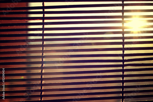 sun shining through the blinds