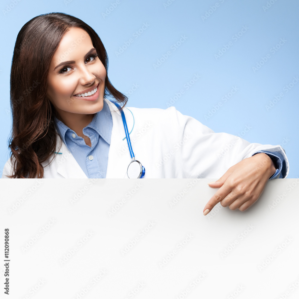 doctor showing blank signboard with copyspace doctor showing blank signboard with copyspace