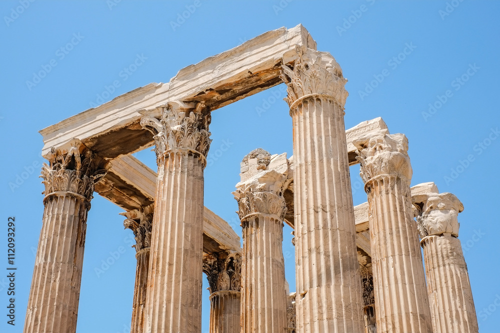 Looking up view of famous Greek temple pillars against clear blue sky in Temple of Zeus, Greece