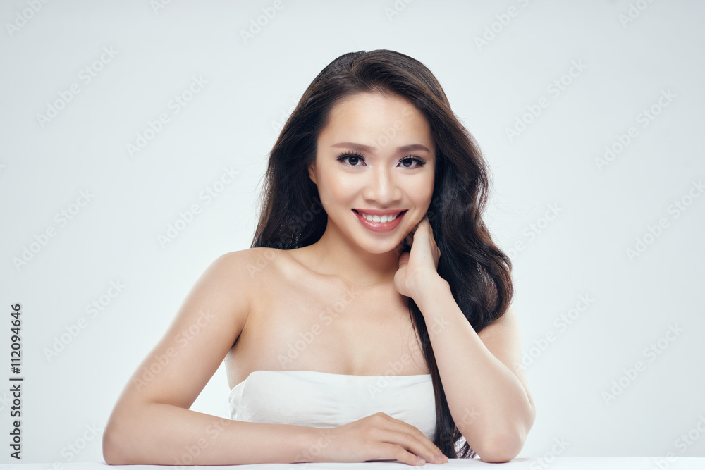 Glamorous Asian woman smiling at looking at camera Glamorous Asian woman smiling at looking at camera