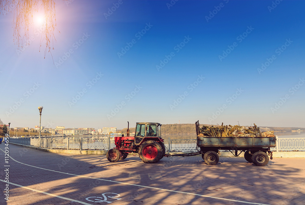 Fototapeta premium Morning in the city park. cleaning, pruning, tractor-trailer car