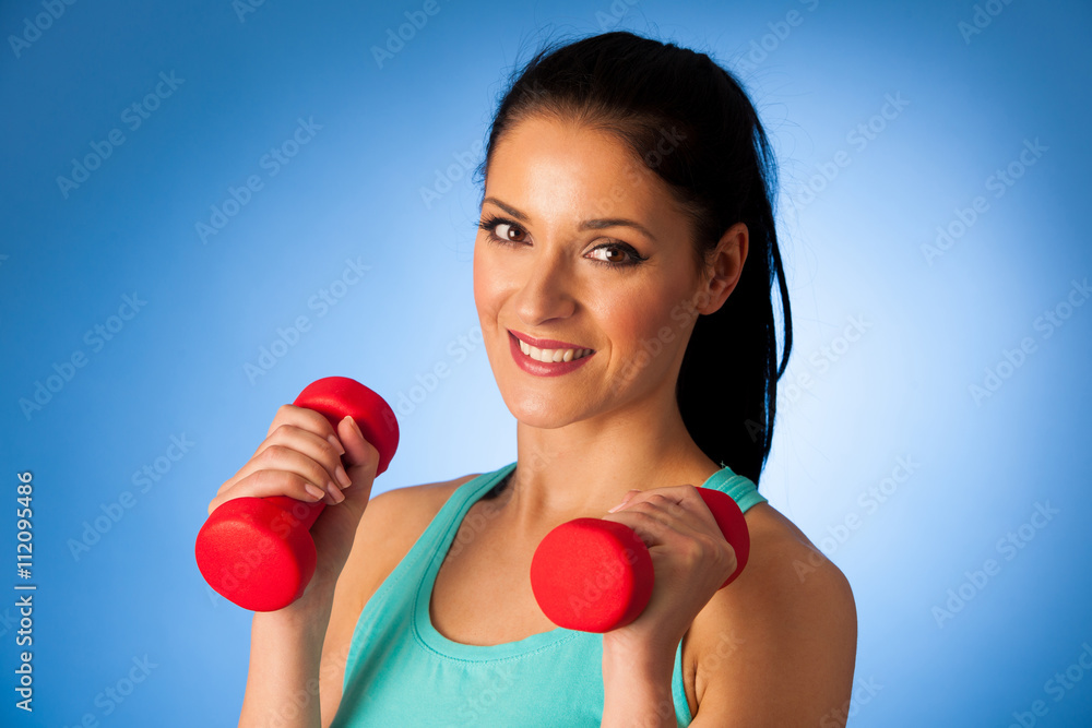 active woman with dumbbells workout in fitness gym over blue bac active woman with dumbbells workout in fitness gym over blue bac