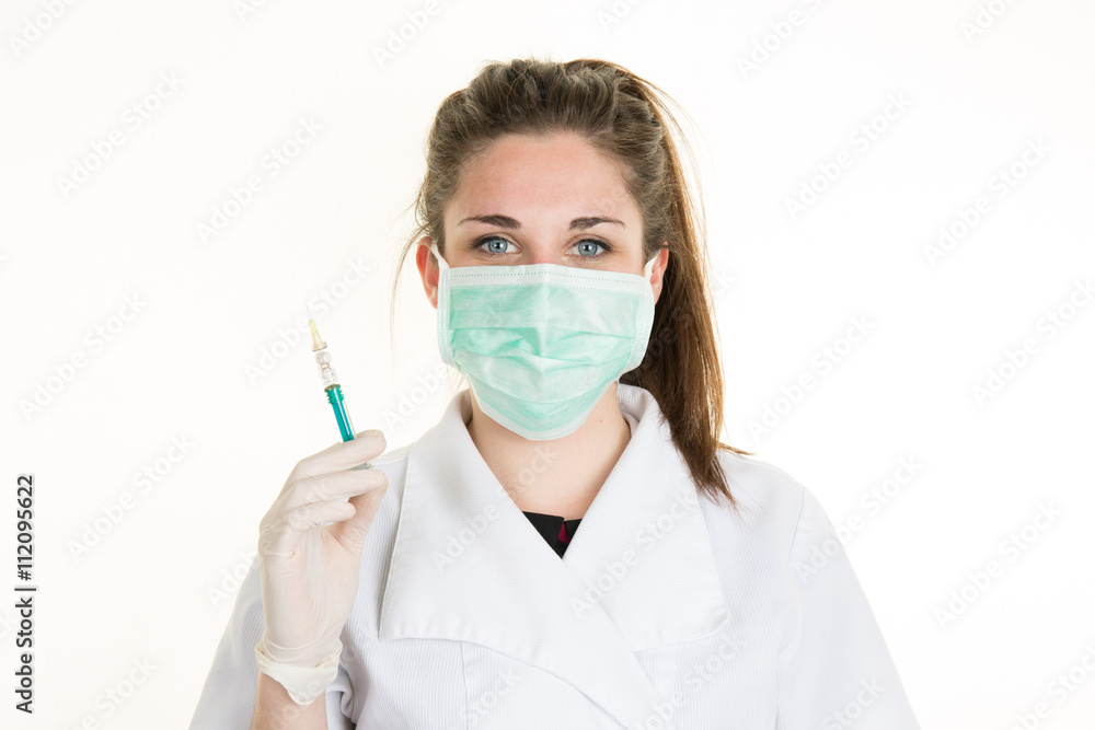 Doctor or nurse in face mask and lab coat holding syringe. Isolated over white. Doctor or nurse in face mask and lab coat holding syringe. Isolated over white.