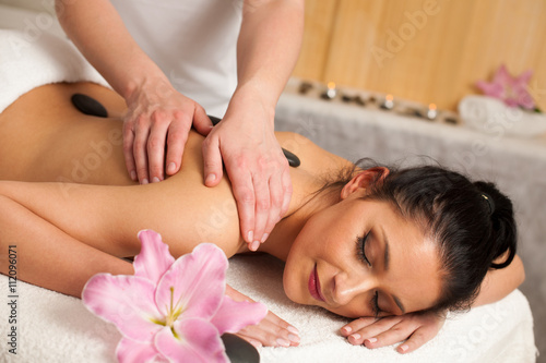 Beautifulyoung woman having a rejuvenating massage in a wellness
