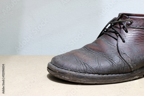 Fashionable men's leather shoes on a dark abstract background. Autumn - spring shoes. brown boots closeup photo