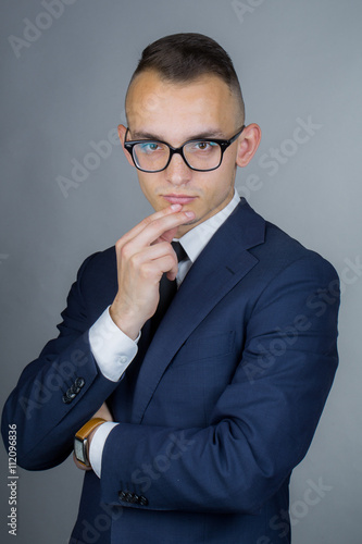 Thoughtful young guy in glasses