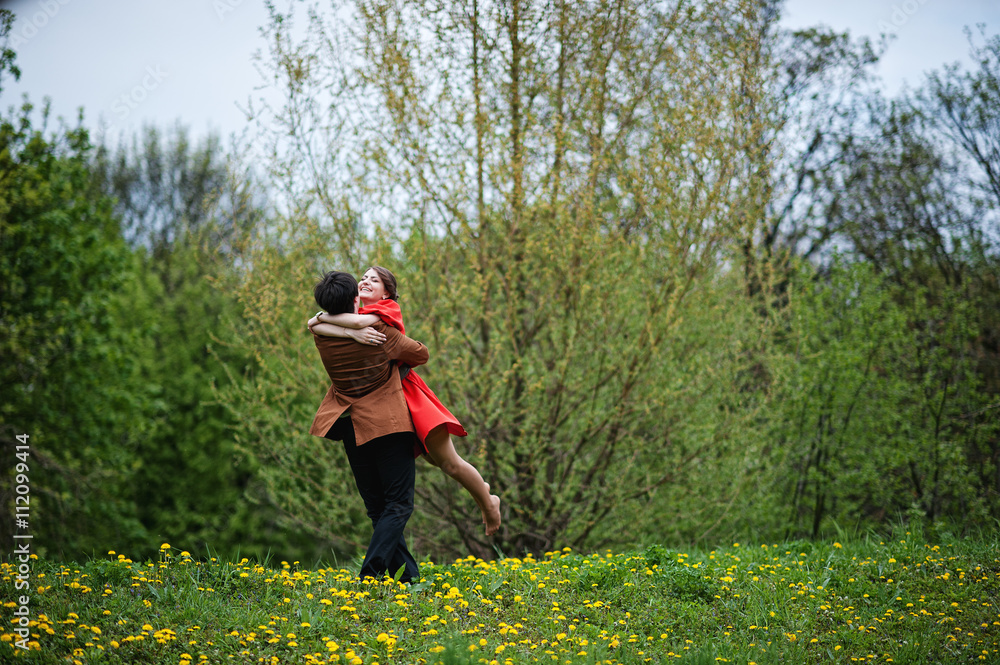 Couple hugging in love background yellow flowers field. Stylish Couple hugging in love background yellow flowers field. Stylish