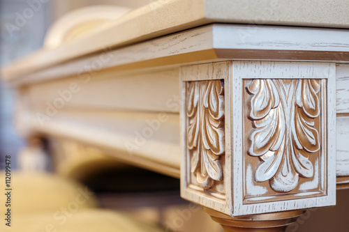  carving element. furniture in classic style. furniture in classic style. white color wood with gold trim. patina. carving. small depth of field. luxury furniture. use as background.