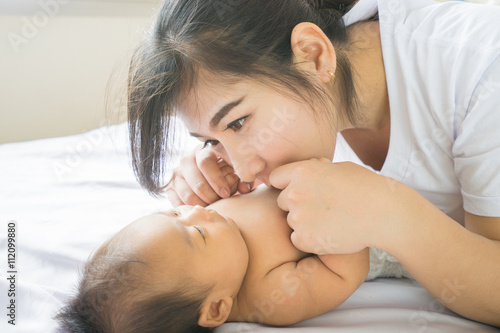 Happy mother holding adorable child baby boy