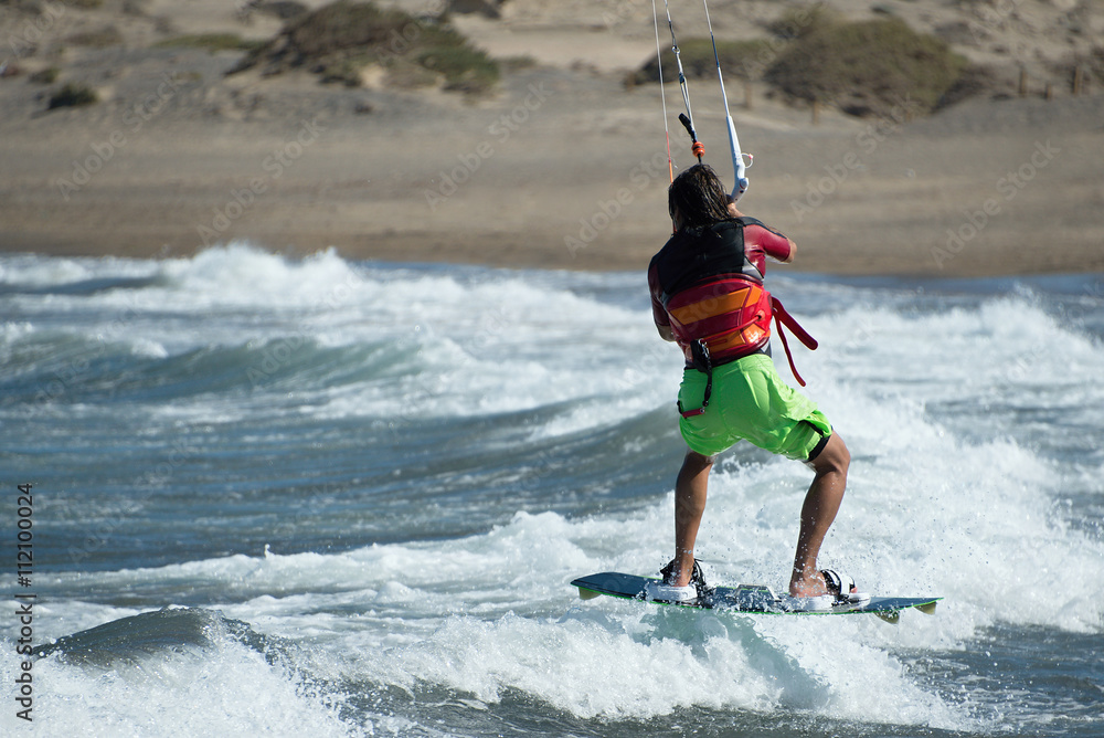 Kitesurfer flying over the wave.Kitesurfing in blue sea Stock Photo