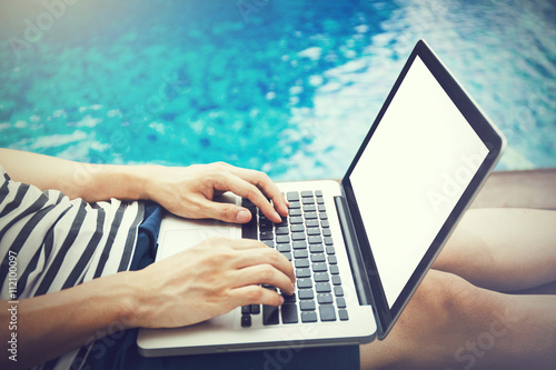 Quadro em tela Screen mockup of laptop that a man is using in the pool on vacation - work anywh