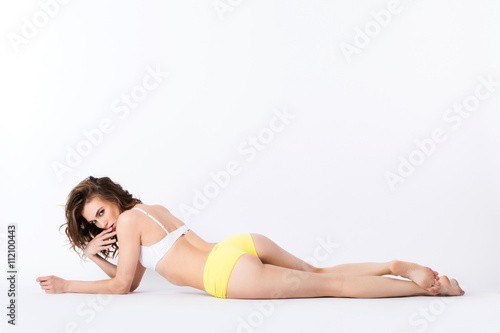 Sexy happy woman with perfect beautiful shape of body lying.