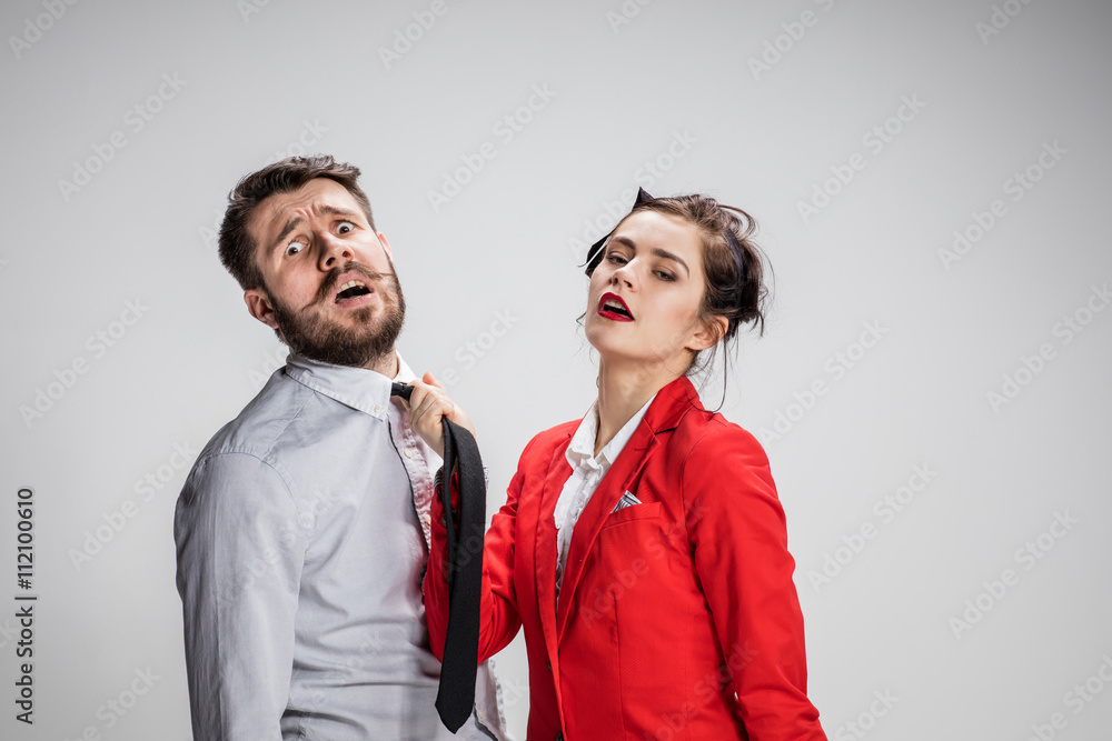 Woman leading a man by his tie Woman leading a man by his tie