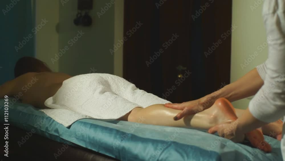 a woman doing a therapeutic foot massage
