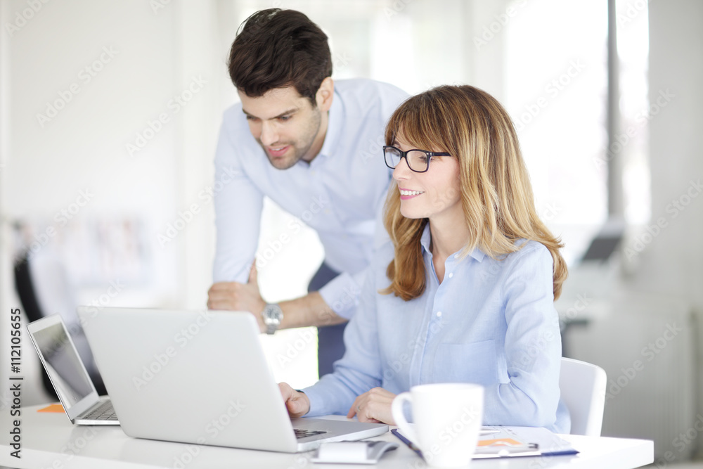 Female boss consulting with her colleague Female boss consulting with her colleague