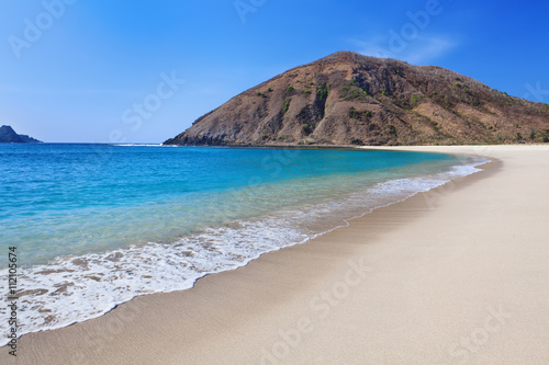 Beautiful scene on best desert beach with white sand, clear water on ocean bay Mawun in tropical island Lombok. Boundless tropic beach with no people in lost paradise. Travel and vacation in Indonesia