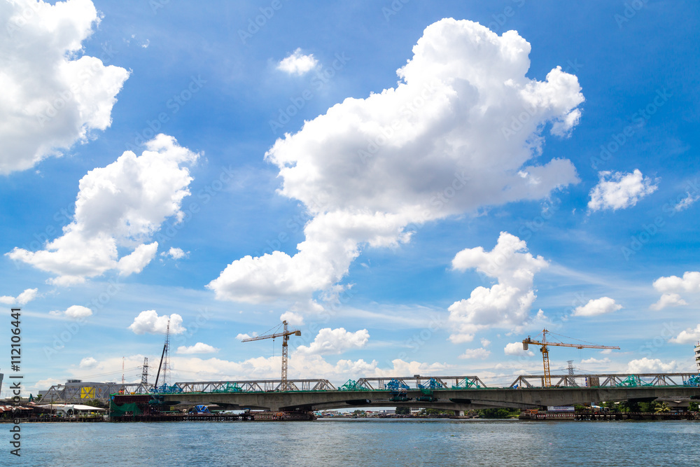 Naklejka premium Cloud on blue sky and land silhouette
