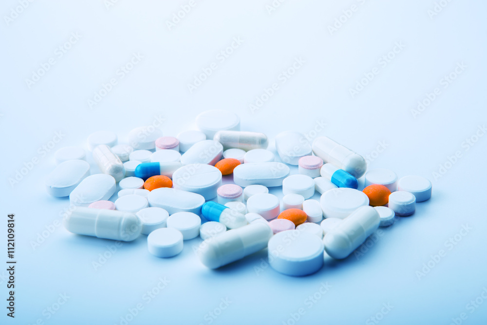 Different colored tablets on a white background close