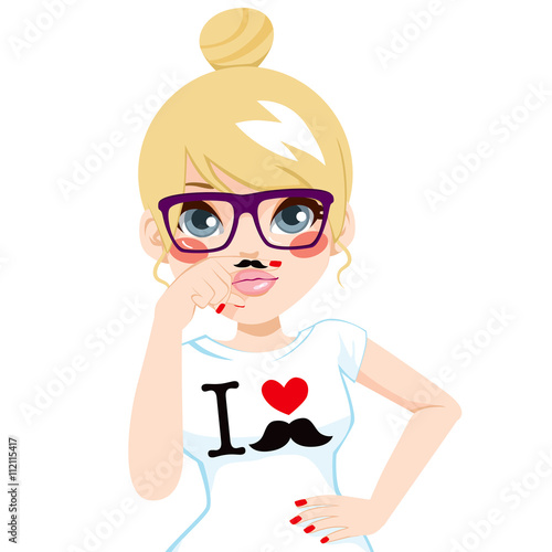 Funny blonde hipster girl making faces pretending to have fake mustache in finger wearing white shirt with I love mustache print design and glasses