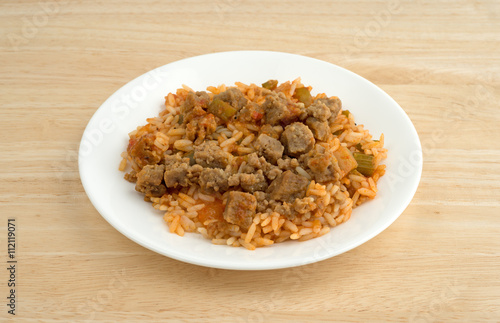 Rice peppers and beef chunks on a white plate