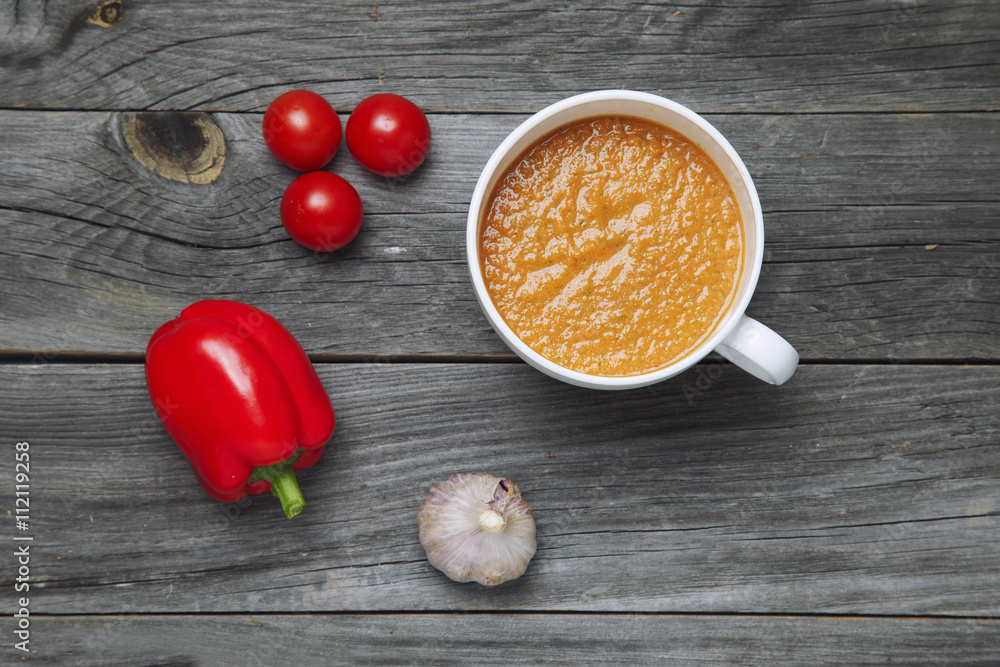 Tomato gazpacho soup with pepper and garlic in black bowl. Top v Tomato gazpacho soup with pepper and garlic in black bowl. Top v