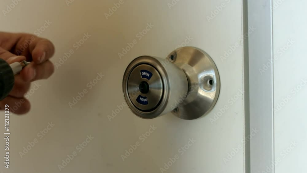Closeup of Fixing the Door Handle Using a Power Screwdriver Closeup of Fixing the Door Handle Using a Power Screwdriver