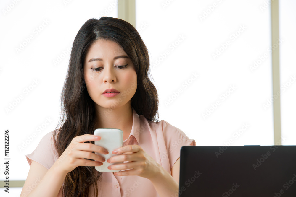 Beautiful young Asian woman using smart phone text messaging Beautiful young Asian woman using smart phone text messaging
