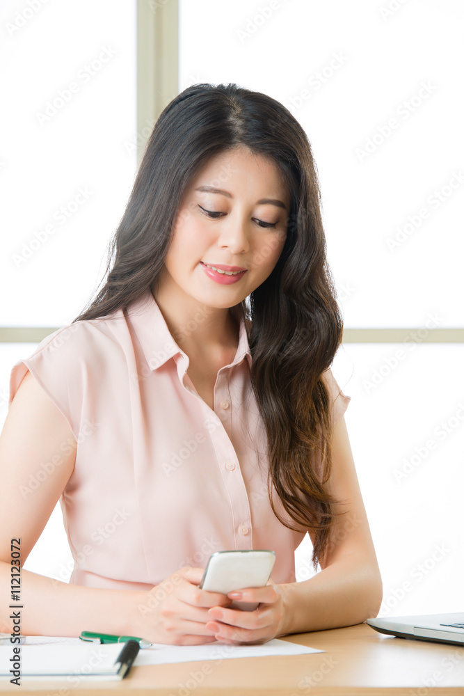 Beautiful young Asian woman using smart phone text messaging Beautiful young Asian woman using smart phone text messaging