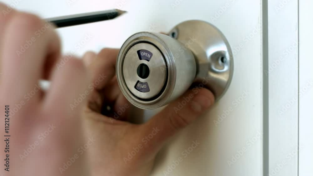 Master Attaches the Door Knob to the White Door Master Attaches the Door Knob to the White Door
