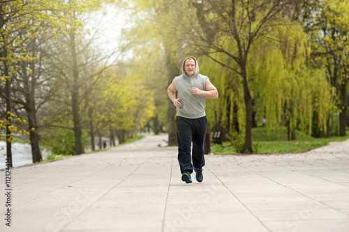 Active man joging in park. Runing fit.