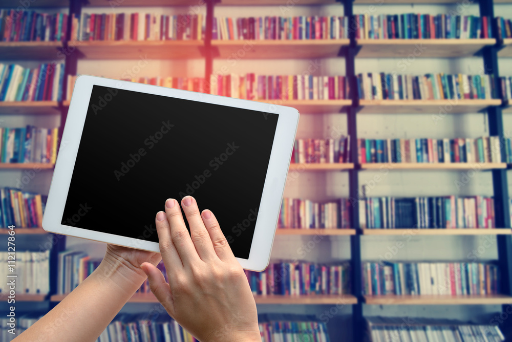 woman hand using the phone tablet with book shelf background woman hand using the phone tablet with book shelf background