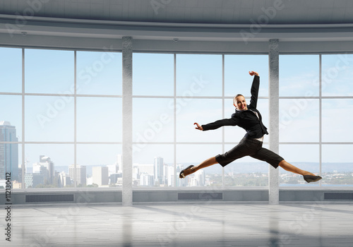 Dancing businesswoman in office © Sergey Nivens