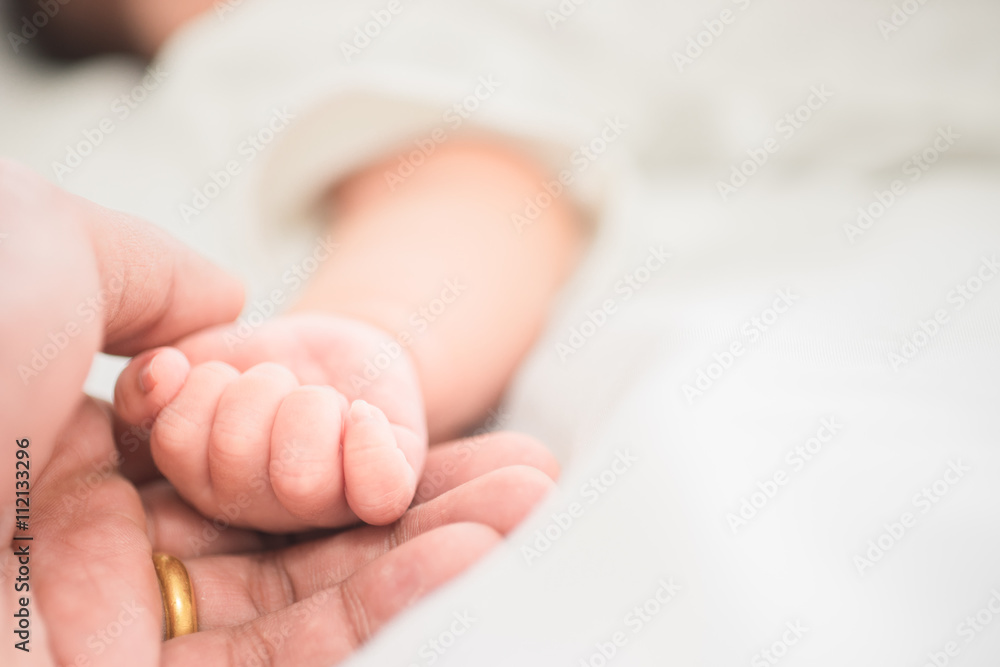 selective focus hand the sleeping baby in the hand of mother clo selective focus hand the sleeping baby in the hand of mother clo