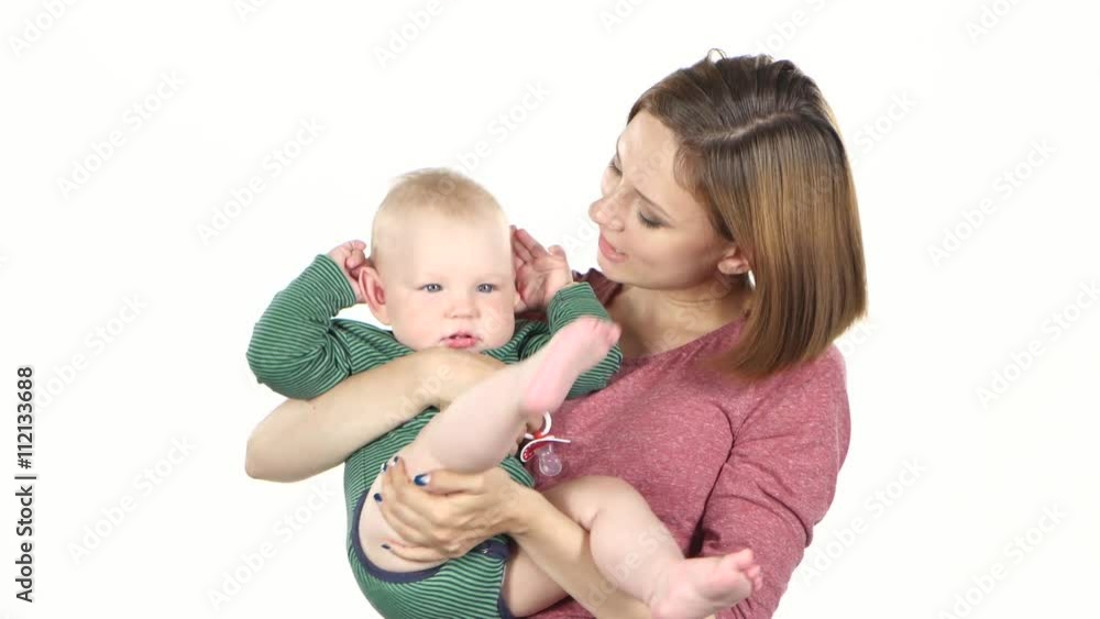 Mother holding her child and playing with him. White Mother holding her child and playing with him. White