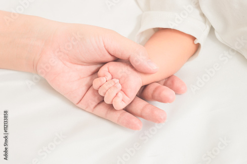 selective focus hand the sleeping baby in the hand of mother clo