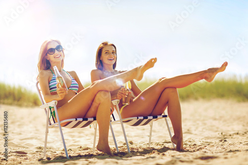 girls with drinks on the beach chairs
