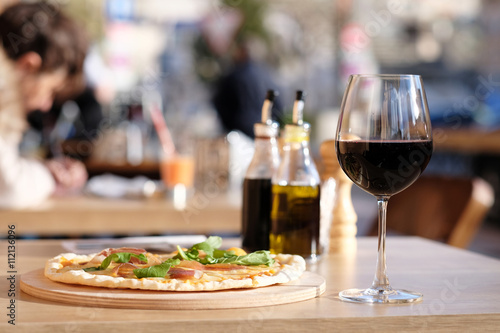 Pizza and red wine in restaurant
