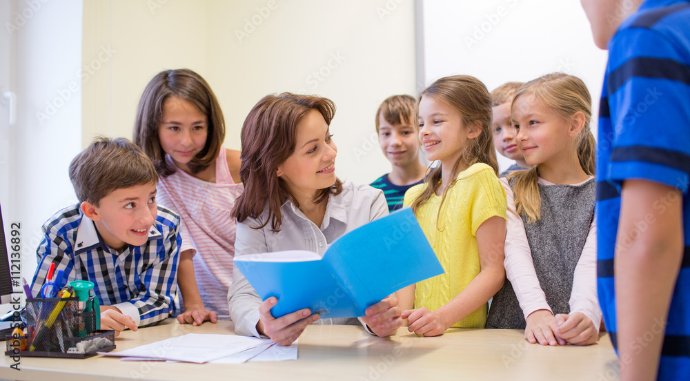 group of school kids with teacher in classroom group of school kids with teacher in classroom