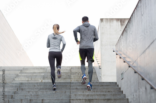 couple running upstairs on city stairs photo