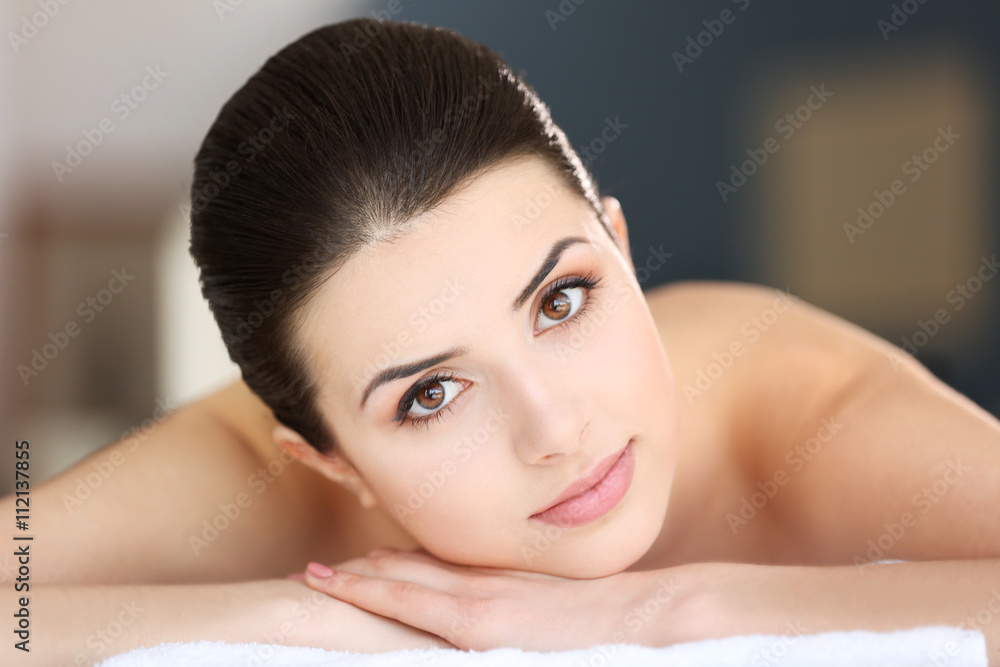 Young woman relaxing in spa center