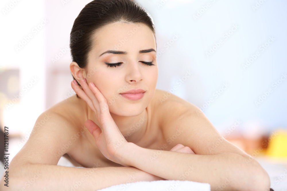 Young woman relaxing in spa center