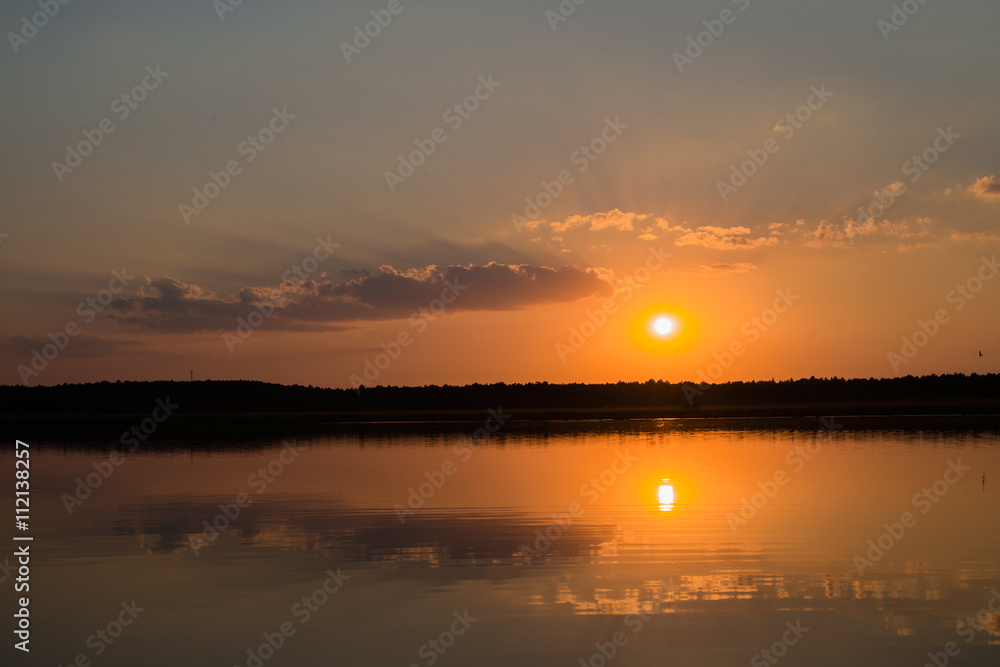 Fototapeta premium orange sunset reflected in water