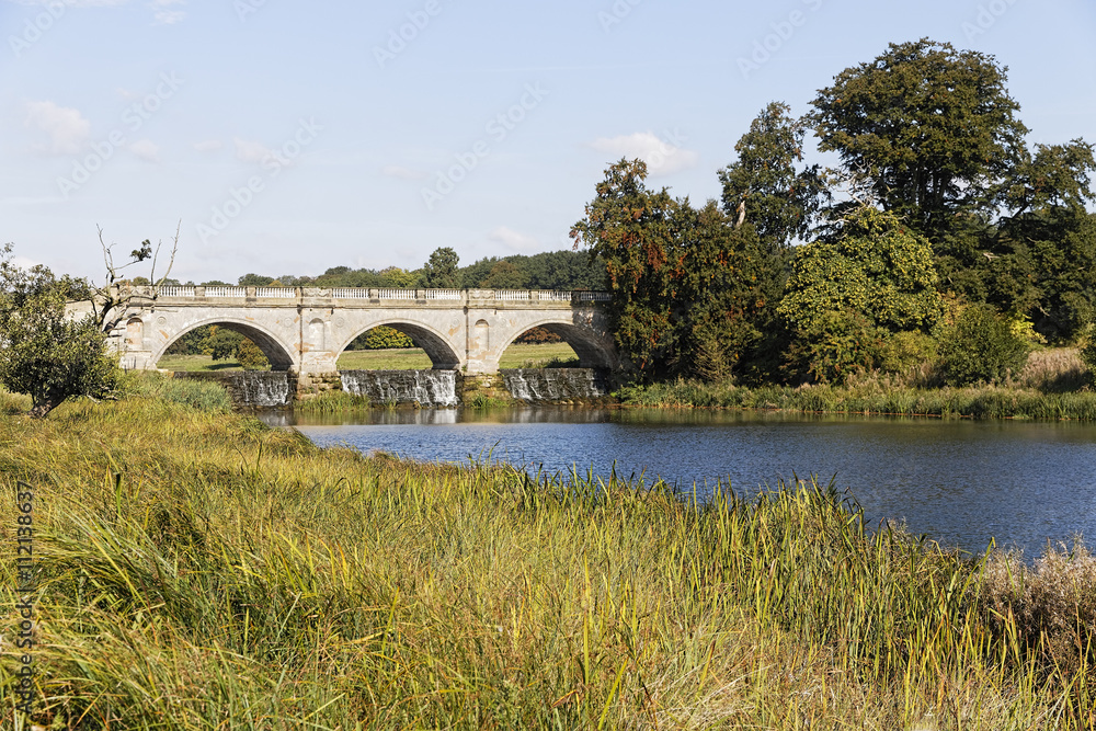 Stone three arch bridge across a river in Derbyshire.